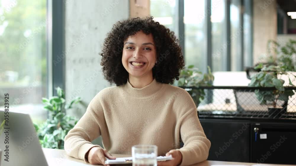 Happy beautiful businesswoman blogger looking talking to camera. Pretty girl recording vlog at office, smiling lady speaking to camera and making video conference call online.