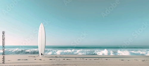 A White Surfboard Standing on a Sandy Beach With Ocean Waves in the Background