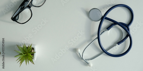 White doctor desk with stethoscope with and eye glasses. Top view with copy space, flat lay photo