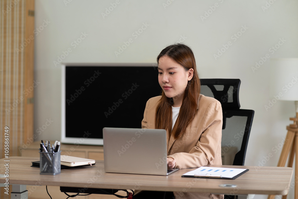 Young business woman using computer at desk in marketing Young business woman using computer at desk in marketing