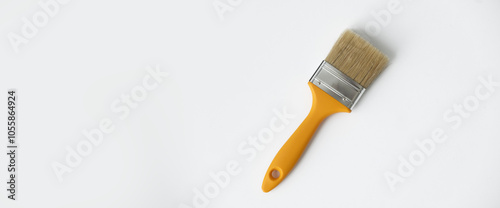 A clean repair brush with a yellow handle on a white background. Build a house. the banner photo