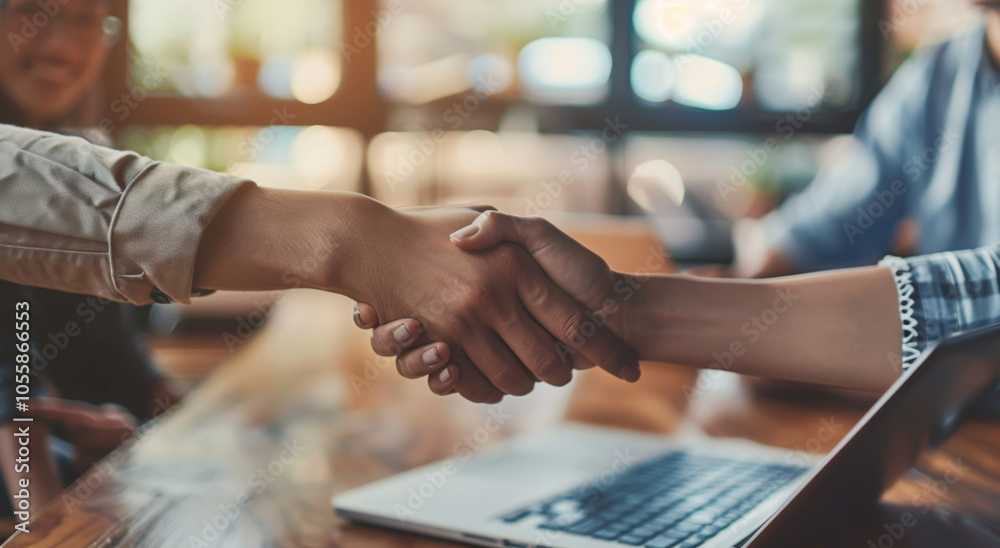 In a restaurant setting, a man and a woman are shaking hands warmly In a restaurant setting, a man and a woman are shaking hands warmly