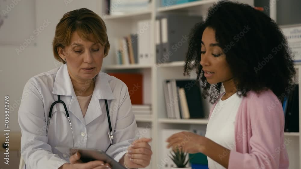 Experienced doctor explaining medical test results to African American woman Experienced doctor explaining medical test results to African American woman