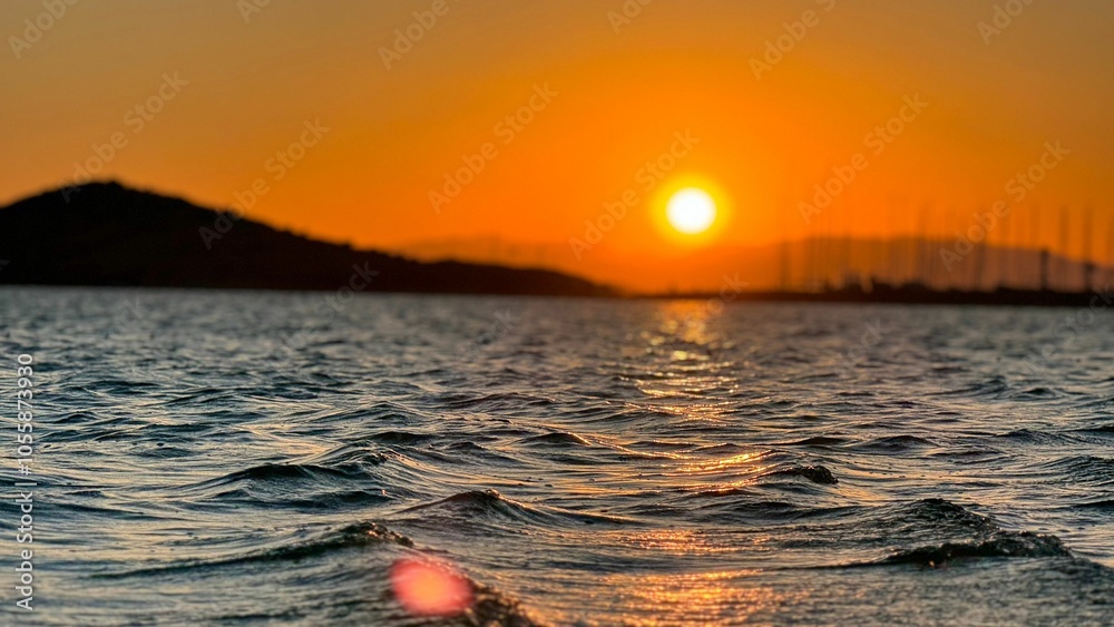 Scenic view of vibrant sunset over ocean waves with golden reflections and a serene horizon Scenic view of vibrant sunset over ocean waves with golden reflections and a serene horizon