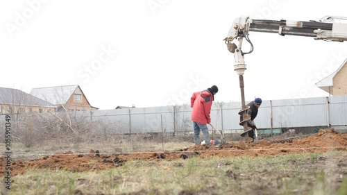 April 2020, Orenburg, Russia. Migrants engaged, guest worker in seasonal construction work. Drilling water wells. Technique for water extraction.