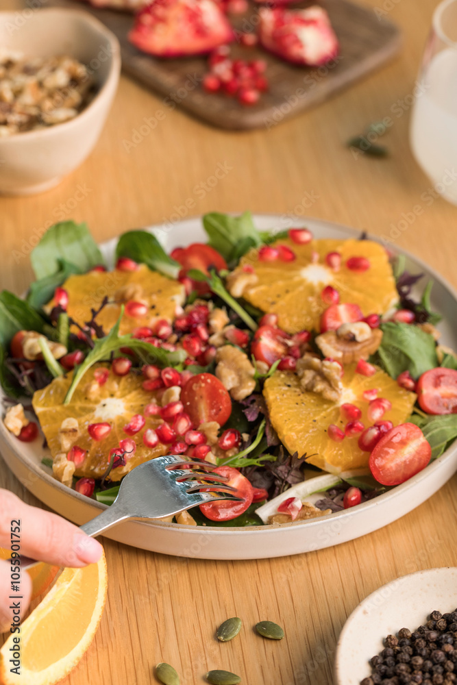 Vegan salad with citrus fruits, lettuce leaves and pomegranate. Christmas salad. 