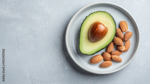 Sliced Avocado and Almonds on White Plate