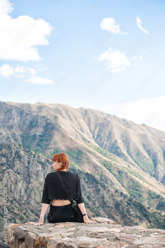 Peaceful mountain scene with a female enjoying the panoramic view Peaceful mountain scene with a female enjoying the panoramic view