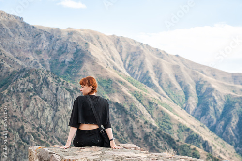 Peaceful mountain scene with a female enjoying the panoramic view