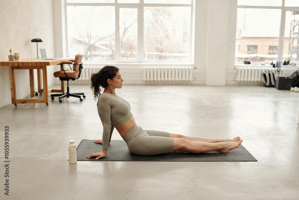 Practicing Yoga in Modern Sunlit Studio Space Practicing Yoga in Modern Sunlit Studio Space