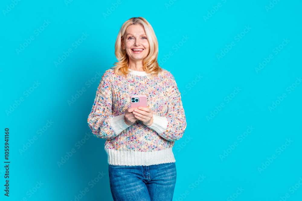 Photo of nice aged woman smart phone empty space wear pullover isolated on teal color background Photo of nice aged woman smart phone empty space wear pullover isolated on teal color background
