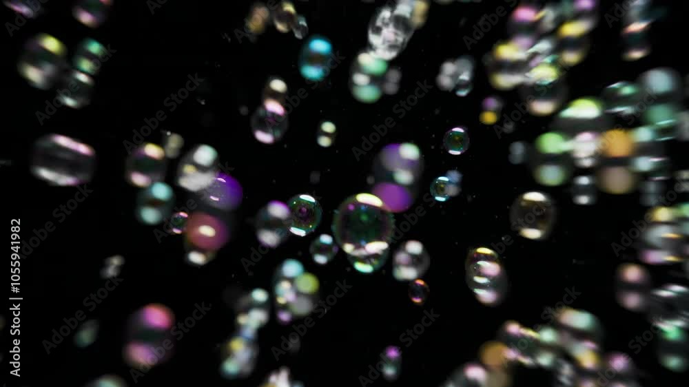 Overlay of many colorful soap bubbles floating in the air on black background. Slow motion. Overlay of many colorful soap bubbles floating in the air on black background. Slow motion.