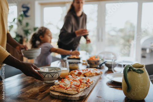 Freshly baked pizza kept on dining table during lunch at home photo