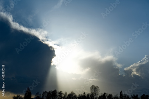 Kyrgyzstan, Karakol. A gloomy view of the setting sun behind heavy storm clouds on the shore of Lake Issyk-Kul. photo