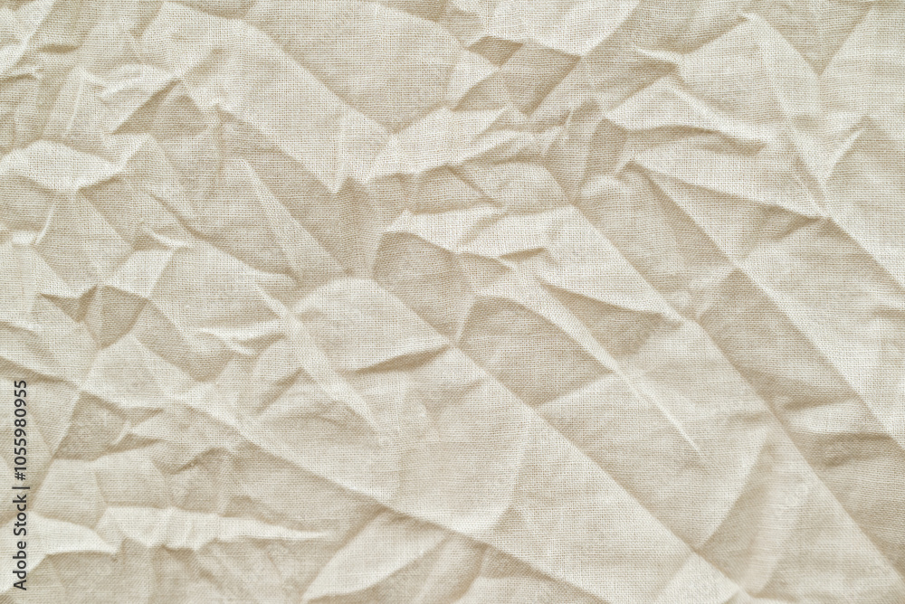 Close up shot of crumpled fabric. Beige natural cotton fabric with many wrinkles, texture background Close up shot of crumpled fabric. Beige natural cotton fabric with many wrinkles, texture background