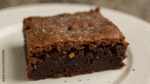 Decadent chocolate brownie served on a white plate.