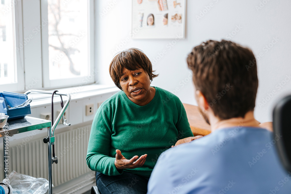 Senior woman gesturing and explaining to male physician while sitting in examination room Senior woman gesturing and explaining to male physician while sitting in examination room
