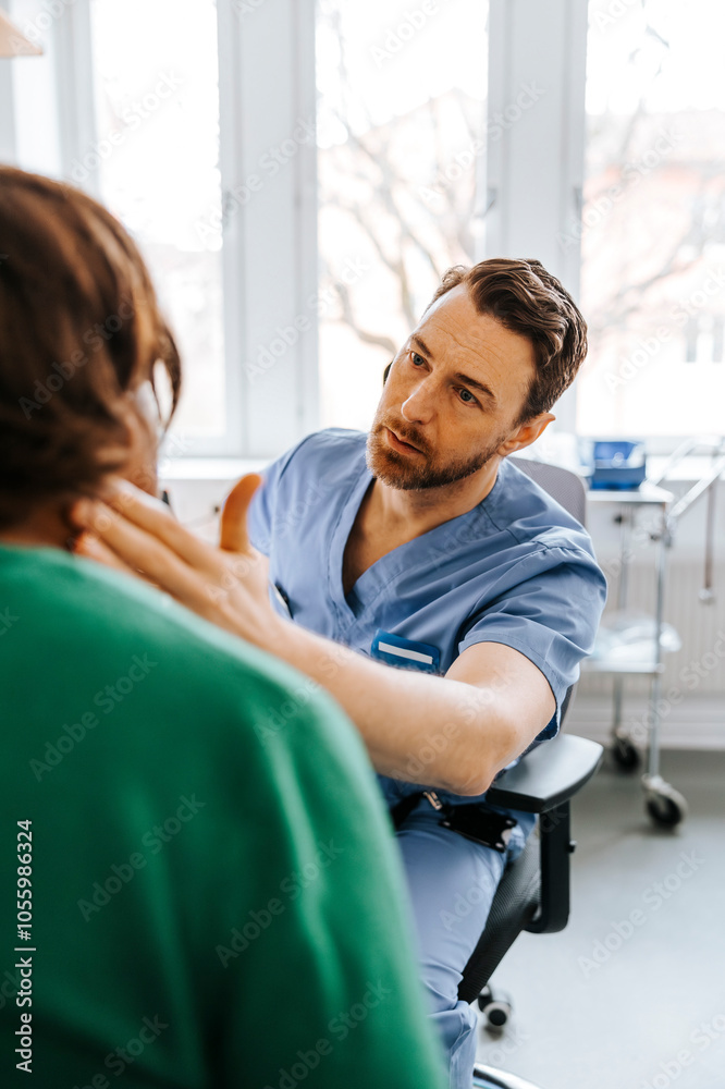 Male medical professional checking neck ache of patient while sitting in examination room Male medical professional checking neck ache of patient while sitting in examination room