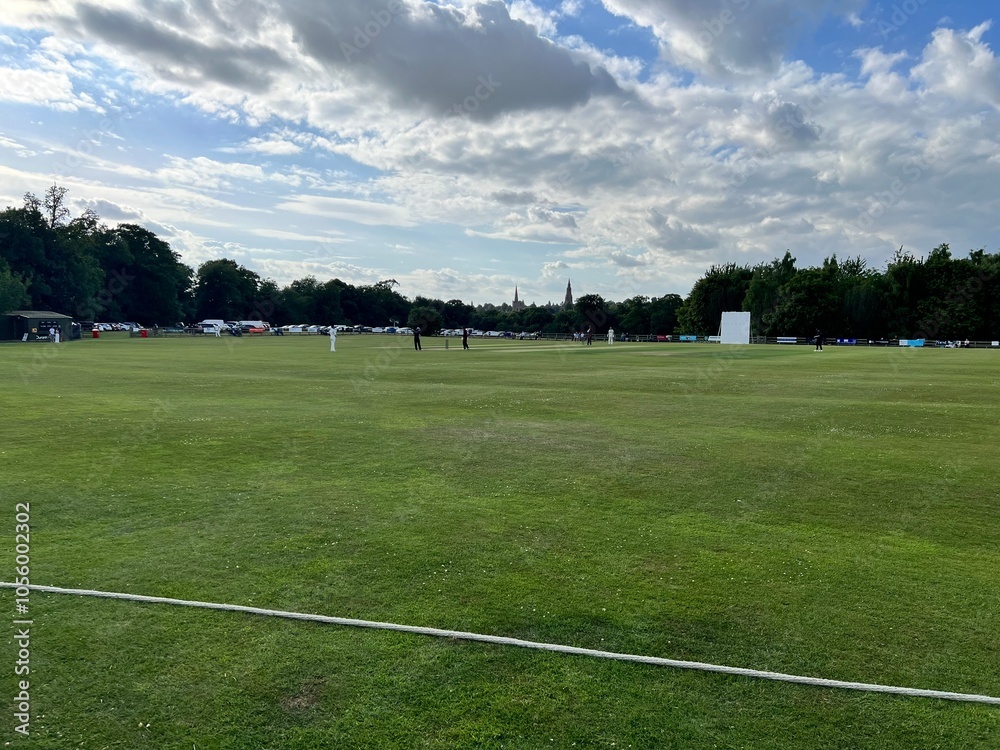 A distant view of an English cricket match during summer A distant view of an English cricket match during summer