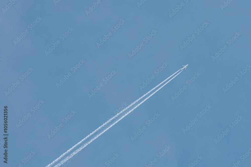 A jet airplane flying at high altitude, leaving a clean, straight contrail across the clear blue sky. The minimalist scene evokes freedom and simplicity in open airspace. A jet airplane flying at high altitude, leaving a clean, straight contrail across the clear blue sky. The minimalist scene evokes freedom and simplicity in open airspace.