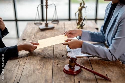 Lawyer delivering legal documents to client in office