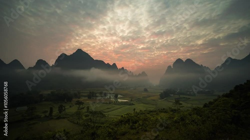 Phong Nam valley with rice fields and mountains and misty morning sunrise in Cao Bang, Vietnam