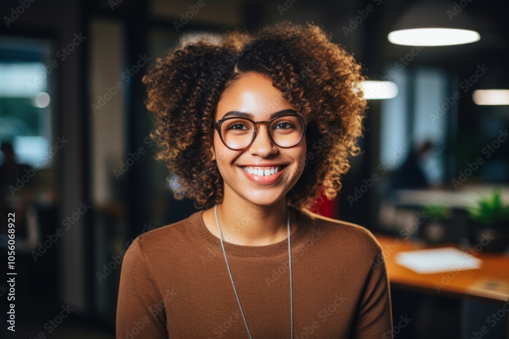 Smiling portrait of a young hipster African American woman in office Smiling portrait of a young hipster African American woman in office