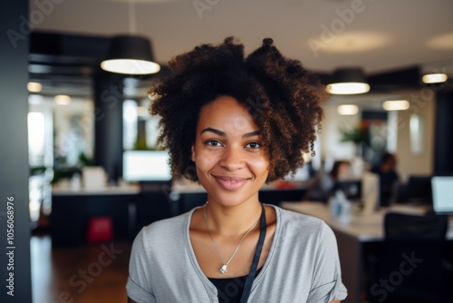 Smiling portrait of a young hipster African American woman in office