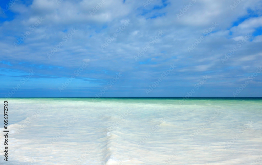 landscape with blue sky and white clouds above and waves of the sea below in many shades landscape with blue sky and white clouds above and waves of the sea below in many shades
