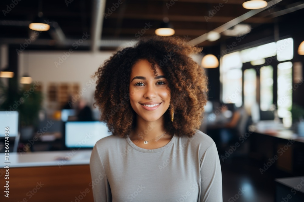 Smiling portrait of a young hipster African American woman in office
