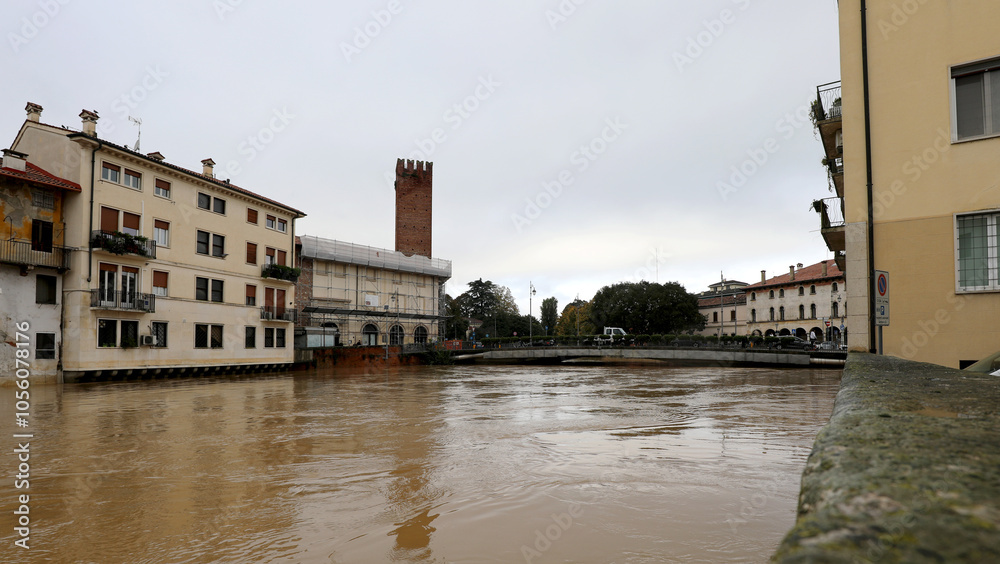 Bacchiglione river and the bridge in the historic center of Vicenza in  Northern Italy during a flood caused by  climate change