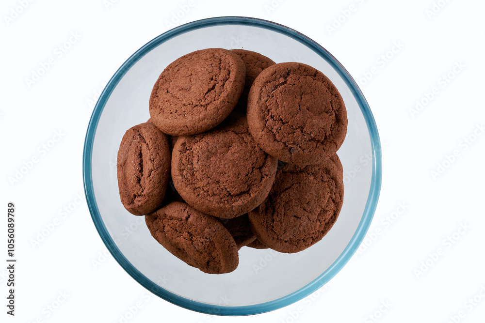 Chocolate cookies in a clear glass bowl isolated on white background, top view. Chocolate cookies in a clear glass bowl isolated on white background, top view.