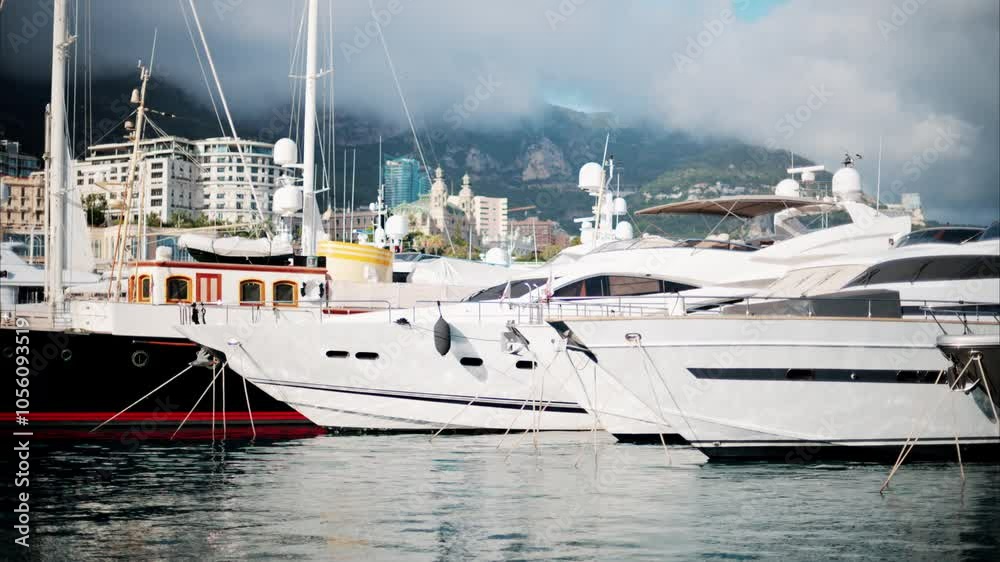 View of boats docked in the Monaco Marina with the skyline of the city on the background View of boats docked in the Monaco Marina with the skyline of the city on the background