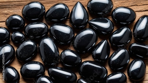 Close-up shot of apache tears stones. The unique, natural shine of these black gemstones adds a powerful, protective energy, perfect for metaphysical or meditation visuals. photo