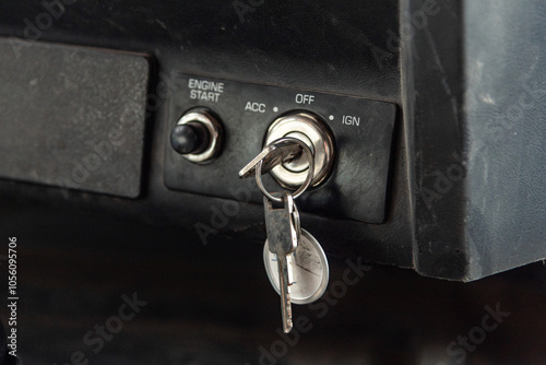 Vehicle Ignition with Key Inserted, Close-Up of Truck Ignition Switch Panel in Off Position, Featuring Start Engine Button and Keychain. Automotive Security, Transportation, and Car Starting Concept