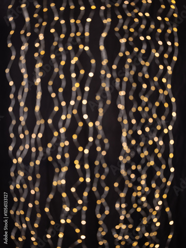 A captivating background featuring cascading golden bokeh lights against a deep black backdrop. The glowing orbs evoke a warm, festive, and elegant atmosphere, perfect for use in holiday, celebration,
