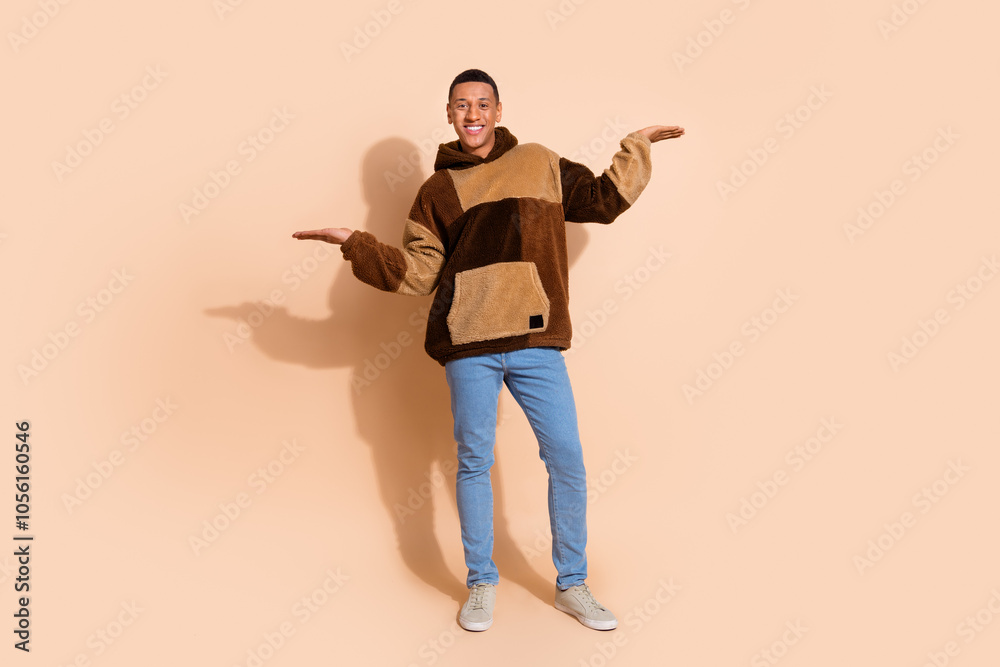 Portrait of nice guy with stylish haircut wear fluffy hoodie palm presenting better option empty space isolated on pastel color background Portrait of nice guy with stylish haircut wear fluffy hoodie palm presenting better option empty space isolated on pastel color background