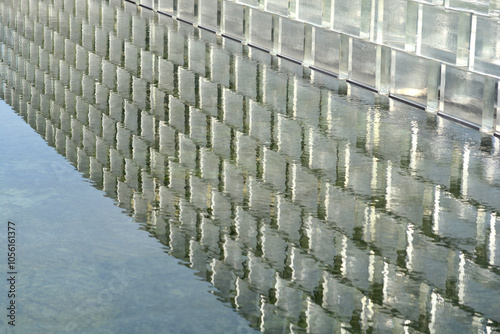 Glass brick wall with reflection in water photo