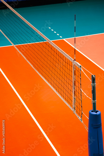 View of professional volleyball court with net in sporty gym indoors. Sport backgrounds, volleyball courts in sport hall. Team game success, healthy sporty lifestyle concept. Copy ad text space poster photo