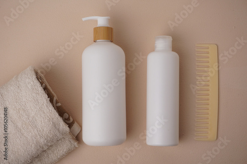 Cosmetic bottle mockup, on a beige background, hand holding the bottle, mockup for branding your product