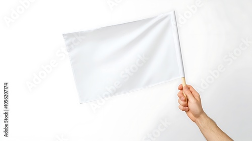A hand holds a white flag with wooden pole on white background.