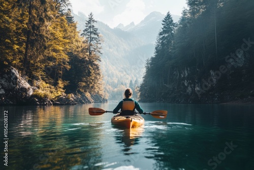 Wallpaper Mural A person kayaking in calm waters surrounded by mountains and trees. The sunlight filters through the trees creating a serene atmosphere. Perfect for adventure and nature lovers. Generative AI Torontodigital.ca