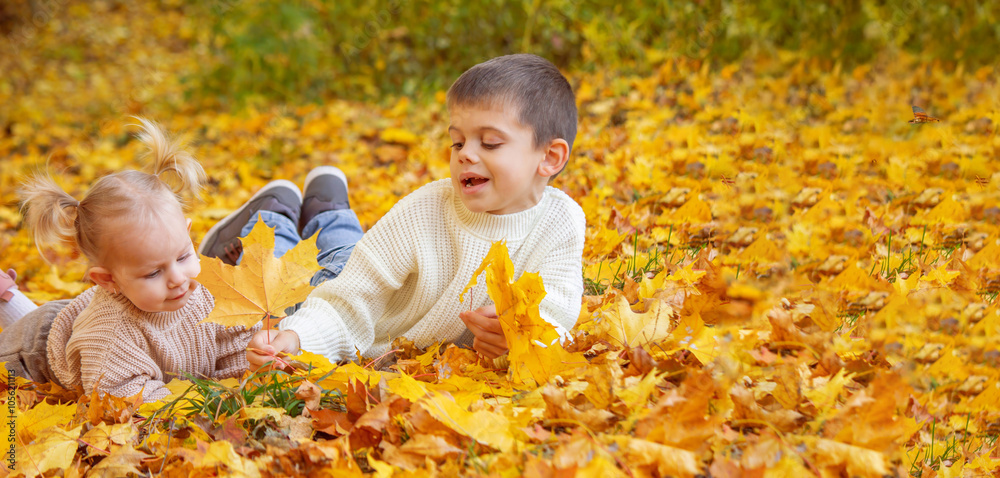 Happy children, boy and little girl in autumn park. Autumn Happy children, boy and little girl in autumn park. Autumn