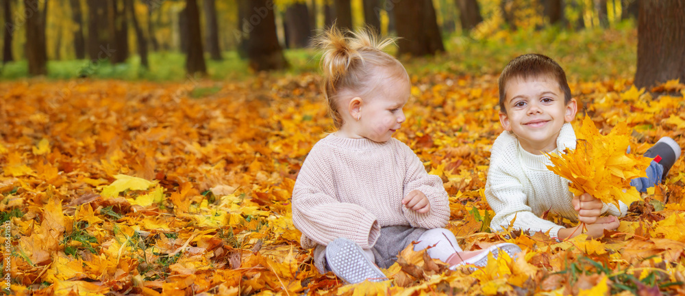 Happy children, boy and little girl in autumn park. Autumn Happy children, boy and little girl in autumn park. Autumn