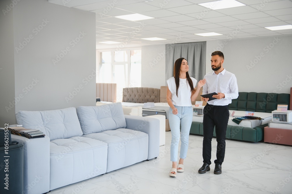 Salesman explaining to woman customer at furniture store Salesman explaining to woman customer at furniture store
