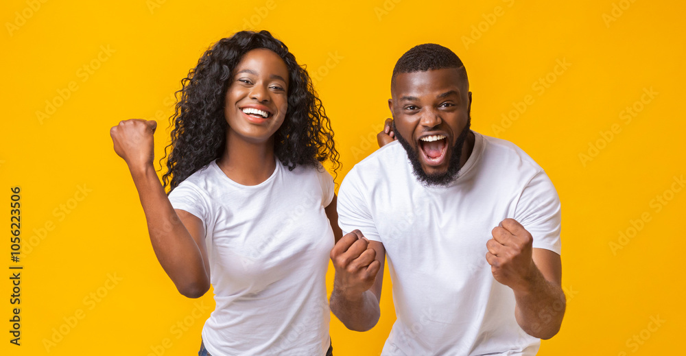 Happy Black Couple Rejoice Success Together, clenching fists and exclaiming, panorama Happy Black Couple Rejoice Success Together, clenching fists and exclaiming, panorama