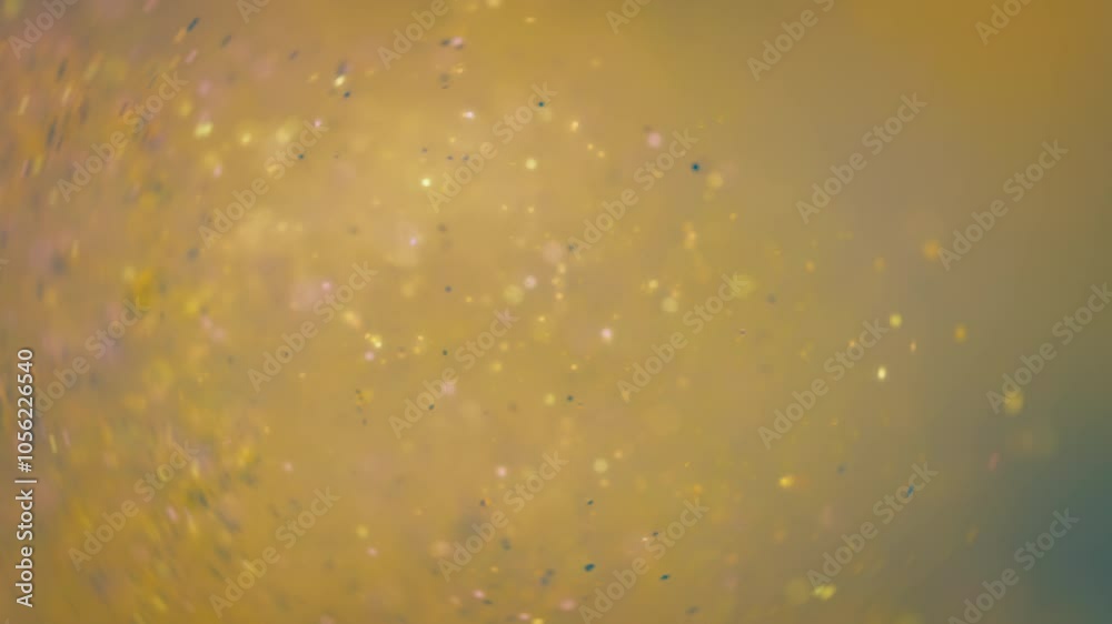 Blue and yellow glitter confetti exploding in slow motion. 
