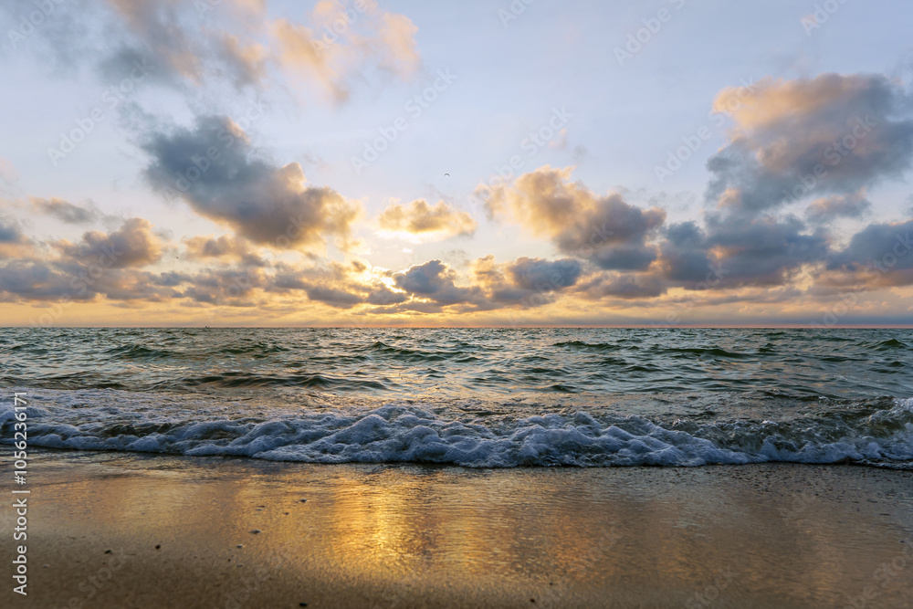 Obraz premium Seascape at sunset. Bright sundown on the sea shore. Sunset on the Baltic Sea.
