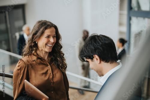 Wallpaper Mural Happy mature businesswoman talking with young male colleague Torontodigital.ca