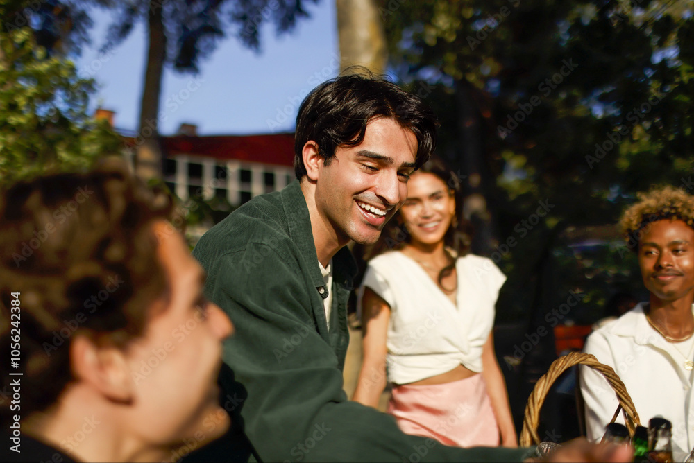 Smiling man enjoying with friends at party in back yard Smiling man enjoying with friends at party in back yard